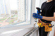 © Angelov - Construction worker installing new window in house