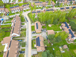 Wall Mural - Aerial drone image of some pretty houses  with solar panels on the roofs reducing CO2 emissions for a better environment.