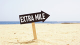 Fototapeta  - Go the extra mile is shown using the text on the road sign