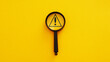 Magnifier glass with triangle caution warning sign for notification error and maintenance concept