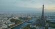 Beautiful view of famous Eiffel Tower in France with magical morning cloud and fog. Wide establishing aerial drone fly over seine river in paris city center, best travel destination landmark in Europe