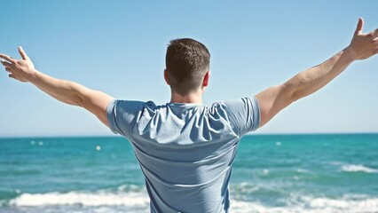 Sticker - Young hispanic man tourist standing with arms open on back view at seaside