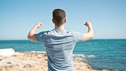 Sticker - Young hispanic man tourist stretching arms on back view at seaside