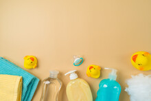 Baby Health Care Products On Modern Background. Infant Shampoo, Oil, Soap, Duck Toys And Towel. Top View, Flat Lay