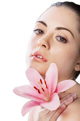 Poster - Close up portrait of beautiful young woman with lily. Isolated on white background. Skin care or spa concept, caucasian