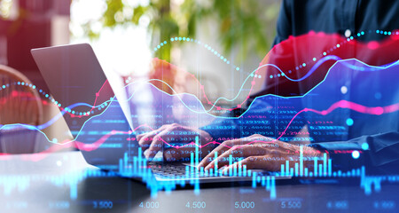 Wall Mural - Man hands with laptop in office, financial graphs