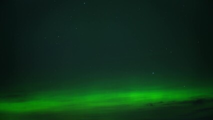 Wall Mural - The Northern Lights exploding with bright green color on the night sky. Timelapse. 