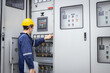 © kanpisut - Electrical engineer working in control room. Electrical engineer man checking Power Distribution Cabinet in the control room