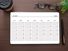 Top View, Tablet Showing May 2023 Calendar App Page And Pen, Tree, Glasses, Coffee Cup On Wooden Table. Business Concept And Education. Calendar Application For Schedule Planning.