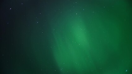 Wall Mural - Rays of Northern Lights lighting up the night sky full of stars. Timelapse. 