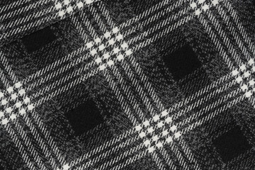 Black and white texture of a plaid fabric from a factory fabric for clothes. checkered clothes background.