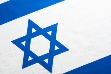 Independence Day of Israel. National Israel flag with star of David over white wooden background. Close up. National flag with place for text.