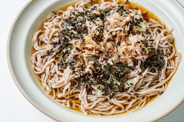 Korean food Naengmemilguksu, a winter delicacy, this buckwheat noodle dish is served in a cold chicken- or beef-based broth and topped with cold slices of beef and egg as a garnish.