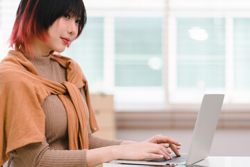 Wall Mural - a creative female ux ui designer is concentrating on the computer screen to design, code, and progra