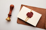 Fototapeta Mapy - Paper envelope with red wax seal and stamp on a table