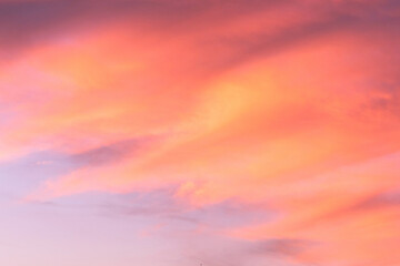 Wall Mural - sky with soft and fluffy pastel coral orange pink and blue colored clouds. sunset background. nature