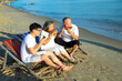 © NVB Stocker - Elderly couple. smiling senior couple eating watermelon on the beach having fun
