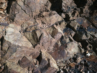 Dark red orange brown rock texture with cracks. Close-up. Rough mountain surface. Stone granite background. rock wall backdrop with rough texture. Abstract, grungy and textured surface