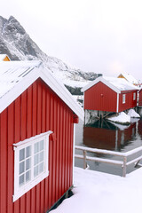 Wall Mural - Traditional wooden houses, rorbuer in the small fishing village of Nusfjord, Lofoten islands, Norway, Europe. Noewegian fjord with fish boats