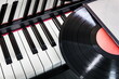 vinyl record lies on the piano keys