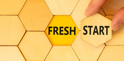 Wall Mural - Fresh start and motivational symbol. Concept words Fresh start on wooden puzzles. Beautiful yellow table yellow background. Businessman hand. Business motivational and Fresh start concept. Copy space.