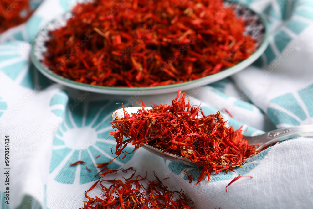 Plate and spoon with pile of saffron on napkin