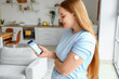 © Pixel-Shot - Woman with glucose sensor using mobile phone for measuring of blood sugar level at home