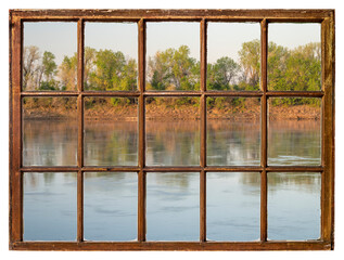  spring sunrise over the Missouri River as seen from a retro sash window