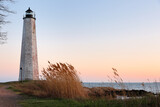 Fototapeta  - Beautiful sunset of New Haven Light House, Connecticut, USA. The lighthouse is dark, but the tower remains, greeting ships from around the world to New Haven. 