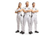 © Ljupco Smokovski - Team of house painters in white overall pants smiling at camera