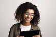 © LAYHONG - Smiling african american woman in eyeglasses using digital tablet, Generative AI