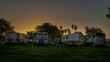 Rv motorhomes parked in row at campsite early morning sunrise
