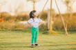 asia baby smile cute girl play on a the outdoor playground with happy time on evening time