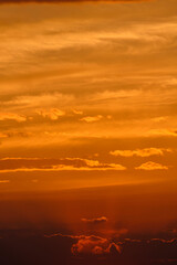 Wall Mural - Clouds yellow sky background during sunset.