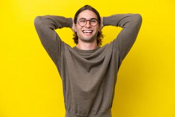 Wall Mural - Caucasian handsome man isolated on yellow background laughing