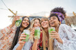 © Vittorio Gravino - Cheerful girls having fun and toasting mojito at bar on the beach . Summer, holiday and leisure concept