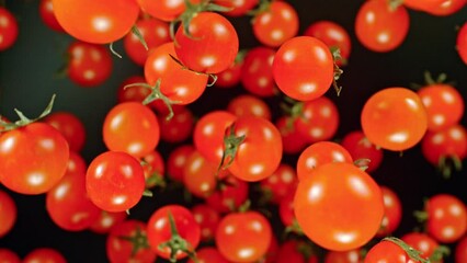 Aufkleber - Super slow motion of cherry tomatoes flying on black background. Filmed on high speed cinema camera, 1000 fps. Camera placed on high speed cine bot, tracking the target. Speed ramp effect.