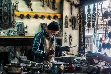 Artisan Blacksmith, Welder In Workshop Working With Rustic Pieces In Iron And Metal. Farrier Handwork. Handicraft In Iron And Steel. 