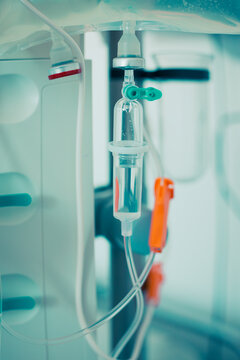 Wall Mural - Close-up of IV tube. Dropper with drug slowly dripping down tube. IV tubes for sick patient after surgery.