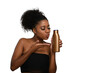 © Edson Souza - a woman kisses an unlabeled bottle of moisturizing cream demonstrating skin care