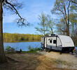 Travel trailer camping in the forest by the lake at Moraine View State Park, illinois