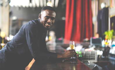 Wall Mural - Portrait of confident African American businessman at nightclub.