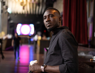 Wall Mural - Portrait of confident African American businessman at nightclub.