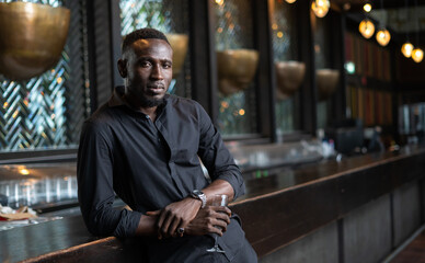 Wall Mural - Portrait of confident African American businessman at nightclub.