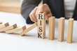 © KMPZZZ - Protection finance, stopping falling block effect collapse domino wooden, Recovery risk business, Management strategy and planning before destroy. Successful intervention.