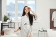 © New Africa - Beautiful happy woman wearing stylish bathrobe in bathroom