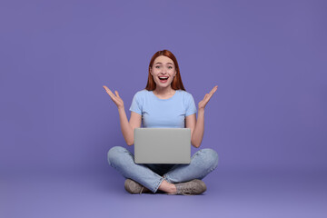 Poster - Happy young woman with laptop on lilac background