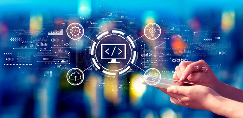 Wall Mural - Web development concept with person using a smartphone at night