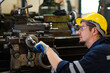 © DG PhotoStock - Professional caucasian white ethnicity male technician operating the heavy duty machine in the lathing factory.
