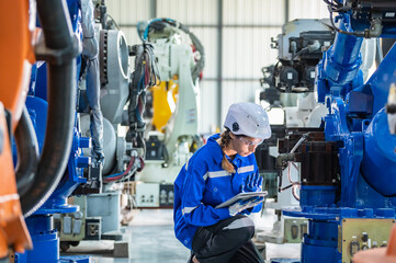 Wall Mural - woman technician engineer worker check heavy machine construction installation in industrial factory. technician worker check for repair maintenance electronic manufacture factory plant industry	